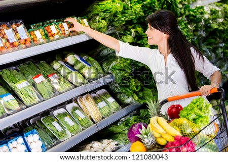 Casual woman grocery shopping at the supermarket