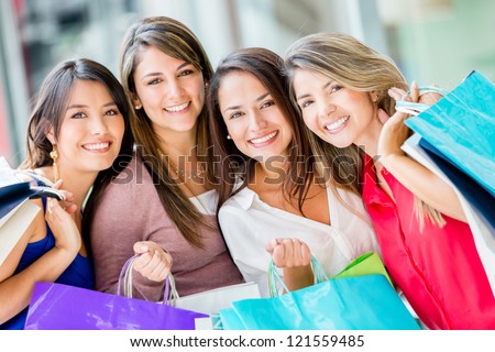 Group of beautiful female shoppers looking very happy