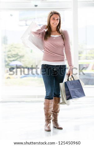 Shopping woman holding bags and smiling