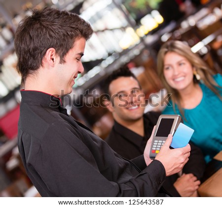 Couple paying by credit card at the restaurant