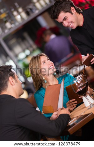Couple at a restaurant ordering to the waiter