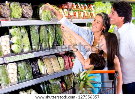 Family shopping at the supermarket and kids helping out Family shopping at the supermarket and kids helping out