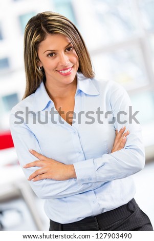 Bossy business woman with arms crossed at the office