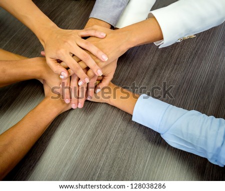 Business Team In A Meeting With Their Hands Together