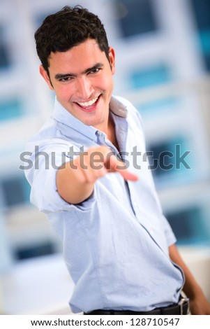 Business man pointing at the camera and smiling