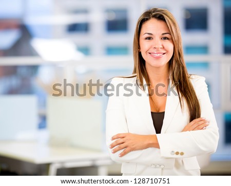 Confident business woman at the office with arms crossed