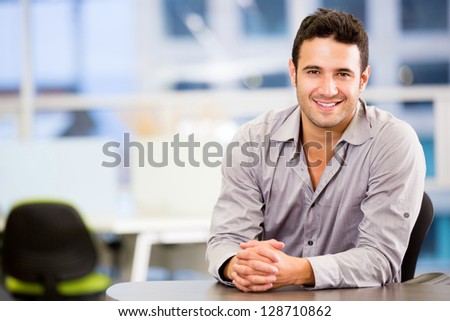 Handsome business man smiling at the office