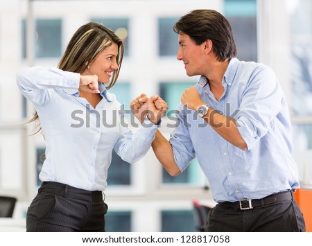 Competitive business couple fighting at the office