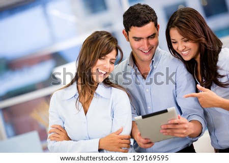 Group of business people working with a tablet computer Group of business people working with a tablet computer