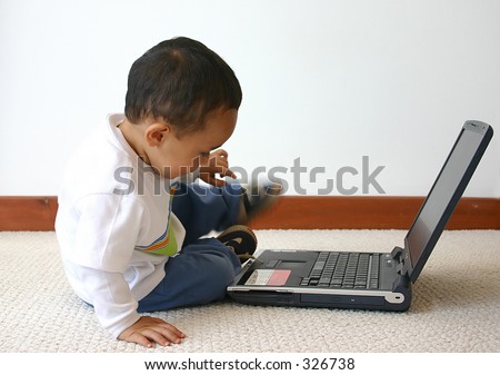 little boy playing around with his laptop
