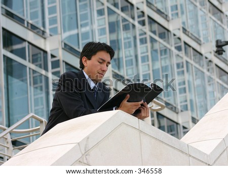 business man reading a magazine in a corporate environment