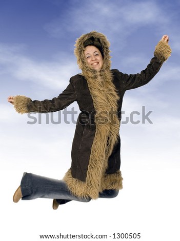 teenager jumping of joy over a wintery background