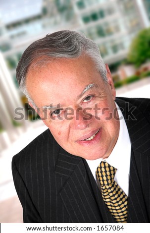 friendly business man in a corporate environment - clipping path included to remove easily from the background