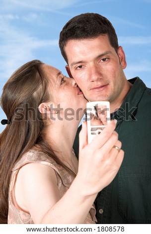 photo of a couple kissing with the sky in the background - clipping path included to easily remove the couple from the background