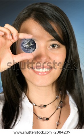 Business woman holding a globe over a dark background