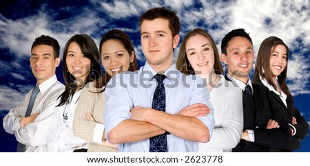 confident business man and his business team - group formed of people from all over the world over a nice blue sky