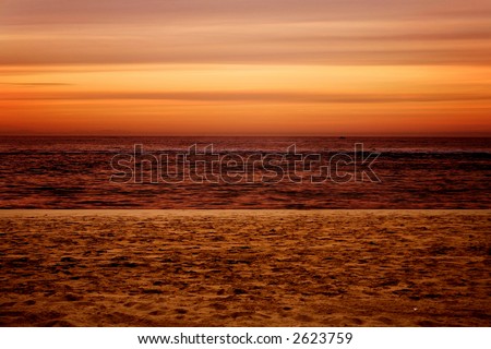 beautiful sunset by the beach in orange colours