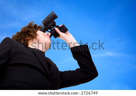 business vision - businesswoman looking through her binoculars over a blue sky