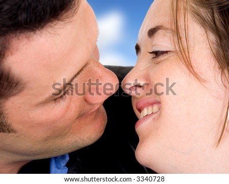 couple of lovers about to kiss - face to face - isolated over a white background