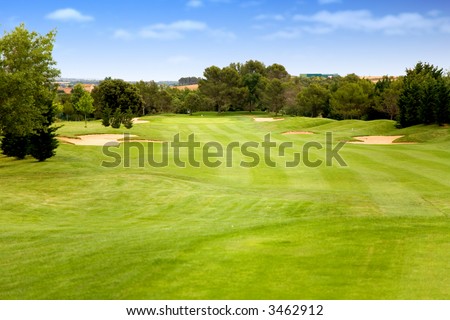 golf course in bright colours on a sunny day with a blue sky