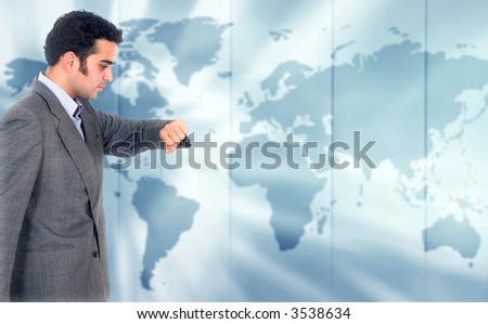 Business man looking at the time with a world map in the background