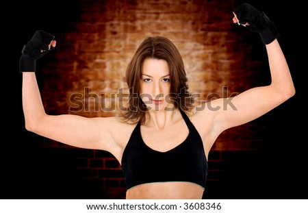 fitness girl training at the gym - over a dark background