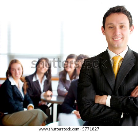 business man leading a team in an office environment smiling
