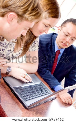 business team on a laptop computer in a restaurant