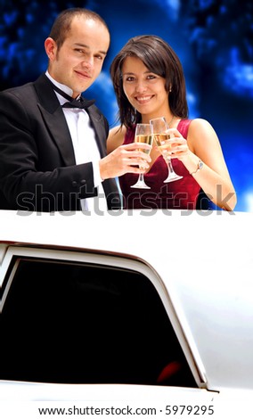 couple coming out from a limousine heading to a party with champagne glasses