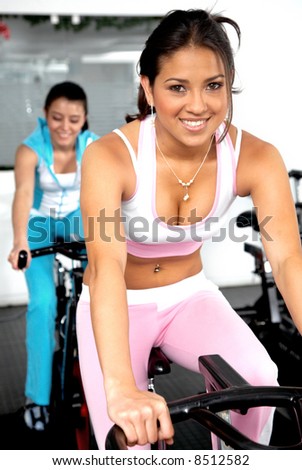girls cycling and working out at the gym girls cycling and working out at the gym