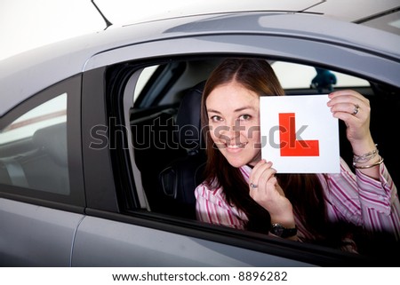 female inside a car learning to drive - studio