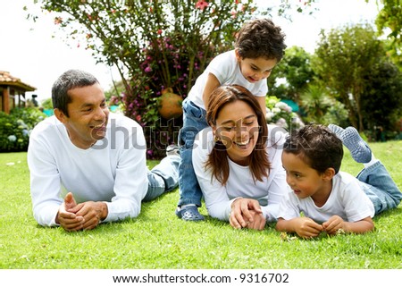 happy family smiling in a portrait of a mum and dad with their two kids happy family smiling in a portrait of a mum and dad with their two kids