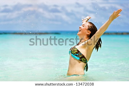 beach freedom woman with arms open having fun in the water