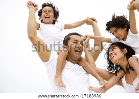 Family lifestyle portrait of a mum and dad with their two kids having fun