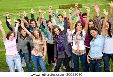 casual students smiling and celebrating success in a park