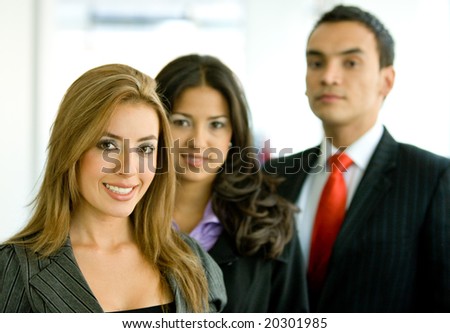 business people in an office smiling - small team