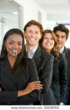 diverse business people in an office smiling - small team