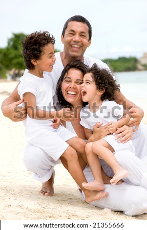 happy family smling at the beach while on vacation