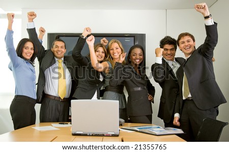 business team in an office full of success looking happy