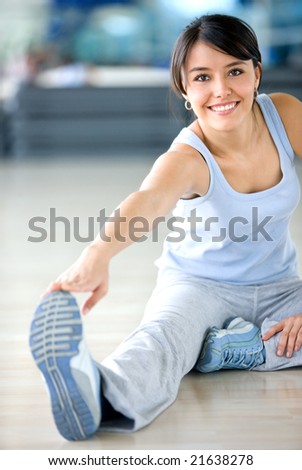 stock photo : gym woman doing stretching exercise at the gym