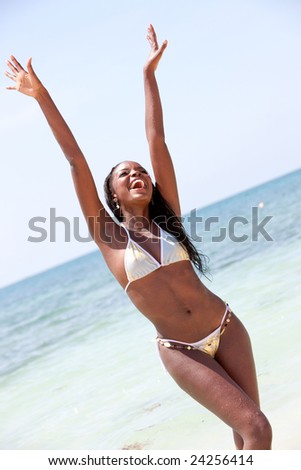 beach freedom woman with arms outstretched having fun