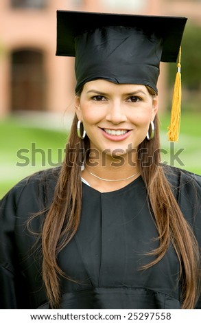 graduation woman portrait smiling and looking happy outdoors