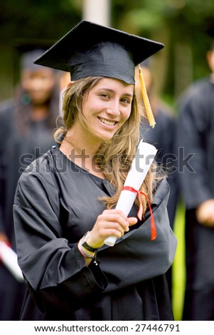 graduation woman smiling and looking happy outdoors