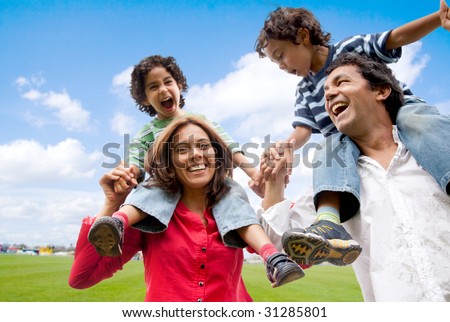 stock photo : happy family having fun in front of their house