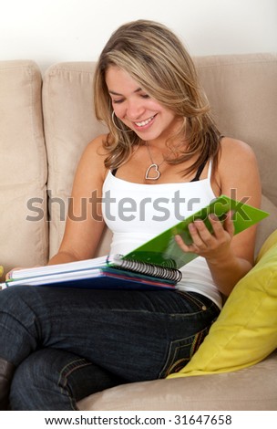 female student studying at home with a notebook