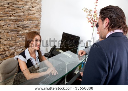 Business couple being attended by the receptionist in an office