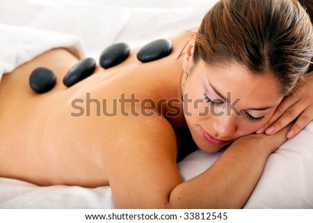Gorgeous woman at a spa having a hot stones massage