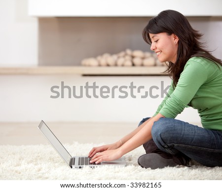woman with a laptop working from home smiling