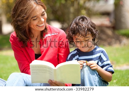 mother and son reading outside togehter