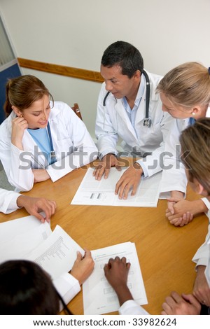 small group of doctors in a meeting discusing a medical history